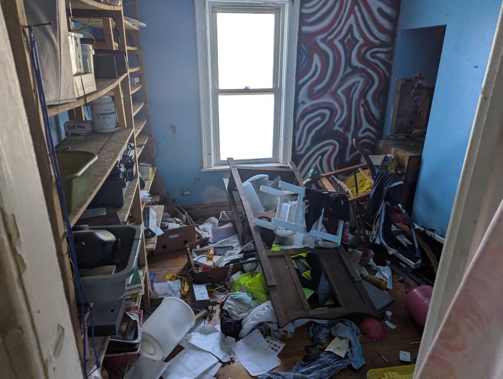 Room filled with items before a property cleanout